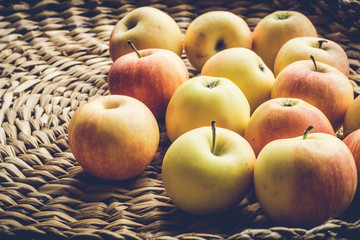 Yellow autumn apples on a straw background. Autumn Harvest Concept