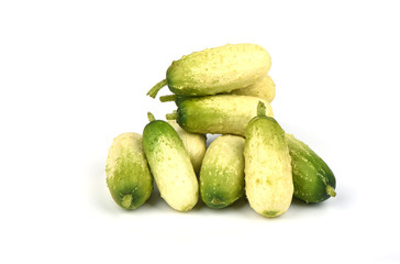 Several organic small cucumbers isolated on white background.