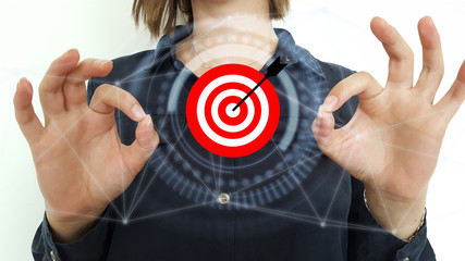 Businessman on blurred background using target and arrow