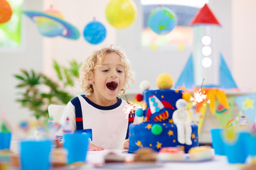 Kids space theme birthday party with cake.
