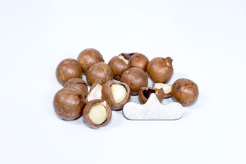Open Macadamia nut by tool on background