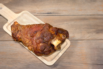 fried pork leg cooked on chopping block