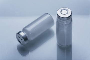 Glass medical ampoule vial for injection. Medicine is dry white drug penicillin powder or liquid...