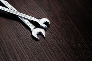 Wrenches on a dark wooden background.  Close-up.