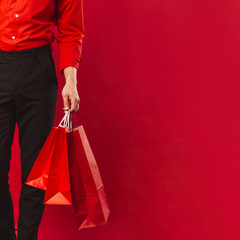 Fototapeta na wymiar Close-up adult man holding shopping bags