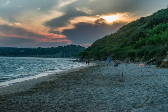 Cloudy sunset view with orange colors at Kanali beach near Lourdata village in Kefalonia, Greece