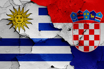flags of Uruguay and Croatia painted on cracked wall