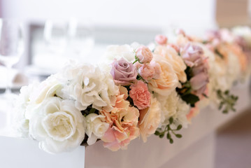 Lovely floral design on the groom and bride 's desk. Roses and cloves