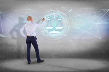 Businessman in front of a wall with justice balance icon on a futuristic interface