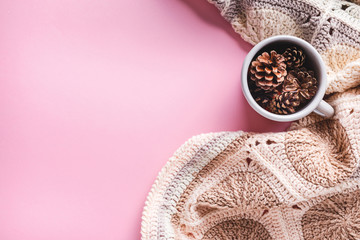 Pine cones in a gray enameled cup, flatlay
