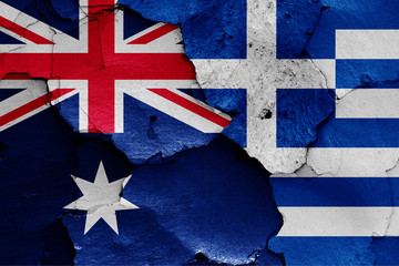 flags of Australia and Greece painted on cracked wall
