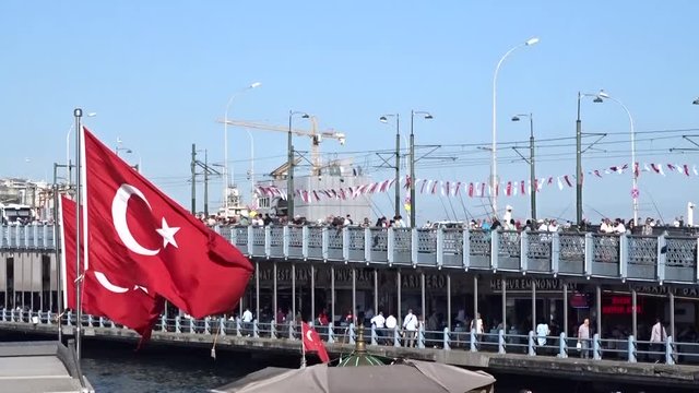 Crowd of people walking around eminonu square, galata bridge and galata tower in istanbul, Turkey