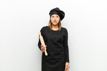 cook woman looking puzzled and confused, biting lip with a nervous gesture, not knowing the answer...