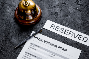 reservation form on hotel reception dark desk background