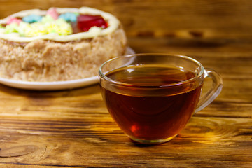 Cup of tea and Kiev cake on a wooden table