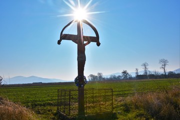the sun above a cross
