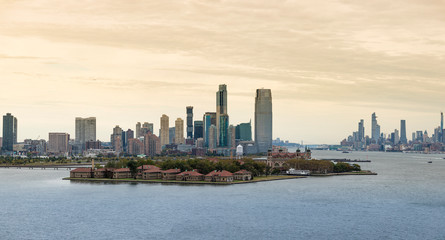 Fototapeta premium View of Ellis Island with Jersey City and Manhattan Island in the background.