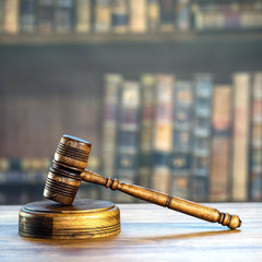 Law and Justice concept. Mallet of the judge, books, scales of justice. Courtroom theme.