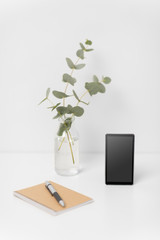 business, electronics and interior concept - smartphone with black screen on white office table