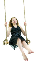 Beautiful teen school girl swinging on a swing. Concept summer v