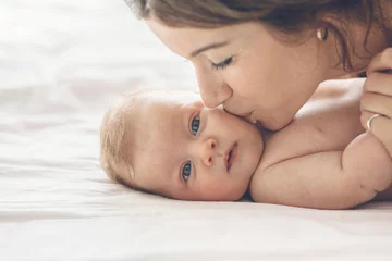 Fototapeten Loving mom carying of her newborn baby at home © Alena Ozerova