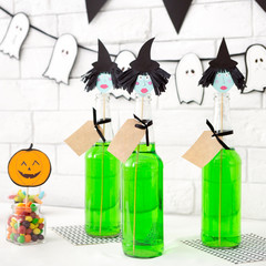 Cute halloween witches ready for party over white bricks wall