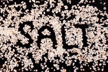 SALT inscription created from himalayan salt on black background