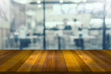 Wooden table with blur restaurant background