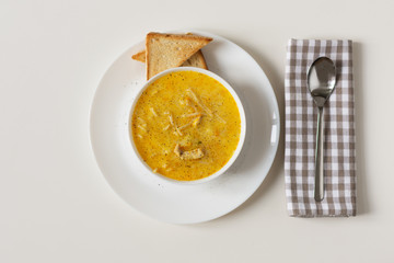 Cream cheese soup with spaghetti and chicken meat at the white background.