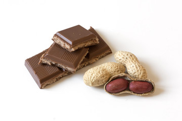 Dried peanut pile and chocolate stuffed with peanut butter isolated on white background. Healthy eating and dieting concept.
