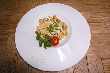 Plate with food on a wooden table.