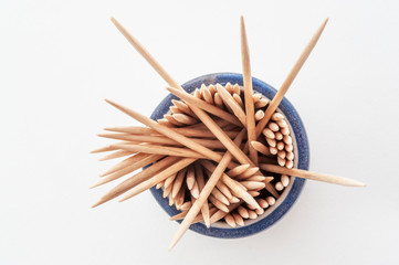 Toothpicks in round beaker, some sticking out
