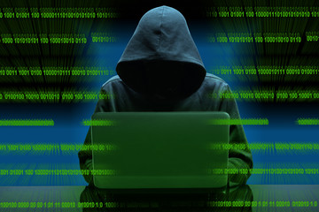 hacker sitting at the desk with binary codes on transparency