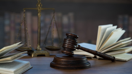 Law and Justice concept. Mallet of the judge, books, scales of justice. Courtroom theme.