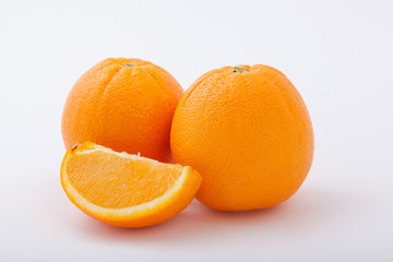 Fresh two whole orange fruit and one segment.