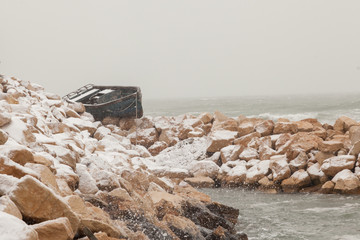 Fishing boat stranded on the shore after a winter storm