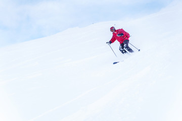 Naklejka na ściany i meble Photo of sports man with red backpack skiing