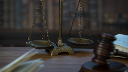 Law and Justice concept. Mallet of the judge, books, scales of justice. Courtroom theme.