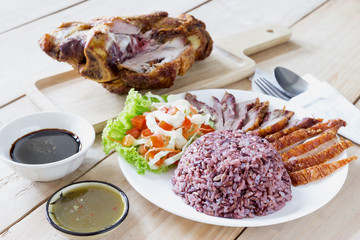 cooked jasmine rice with salad and fried pork leg cooked
