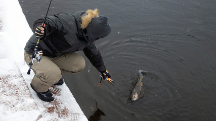 Fototapeta na wymiar Winter fishing for rainbow trout. Area fishing