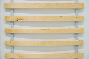 Close up detail of wooden elements double bed slatted mattress base.