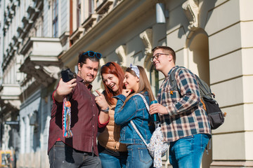 Happy multiracial friends group taking selfie
