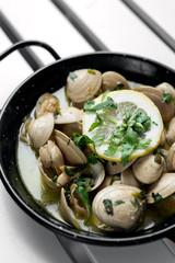 sauteed clams tapas in lemon garlic parsley sauce in spain