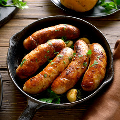 Roasted sausages in frying pan