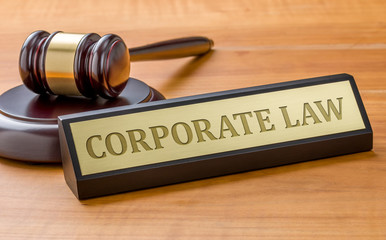 A gavel and a name plate with the engraving Corporate law