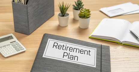 A folder on a desk with the label Retirement Plan