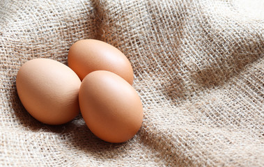 Heap Organic brown Eggs of chicken uncooked freshness  nutrition healthy on brown sack for background texture soft focus close up