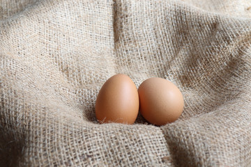 Heap Organic brown two Eggs of chicken uncooked freshness  nutrition healthy on brown sack for background texture soft focus close up