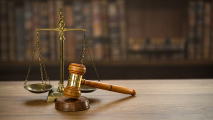 Law and Justice concept. Mallet of the judge, books, scales of justice. Courtroom theme.