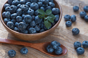 blueberries in a bowl on wooden table